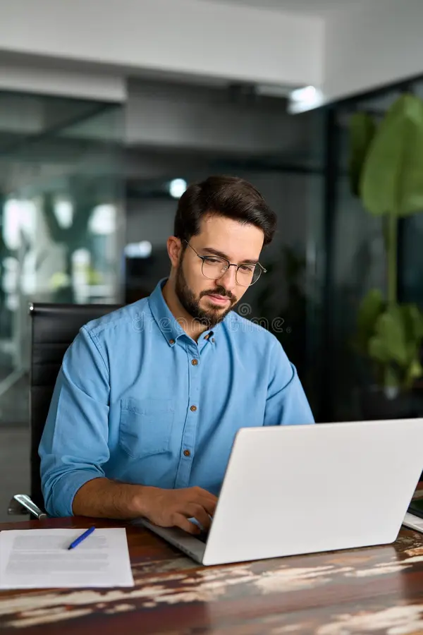 Professional working on a laptop computer displaying offline data recovery and email management software in a modern workspace